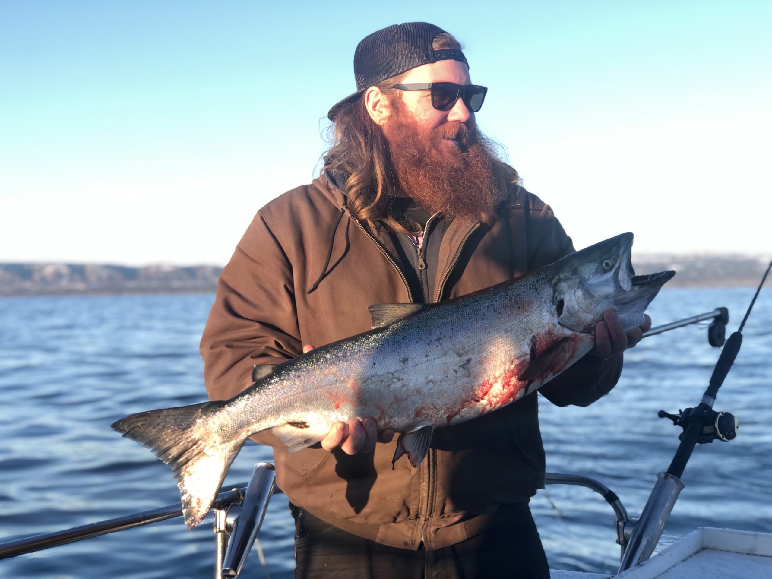 a man holding a fish in the water